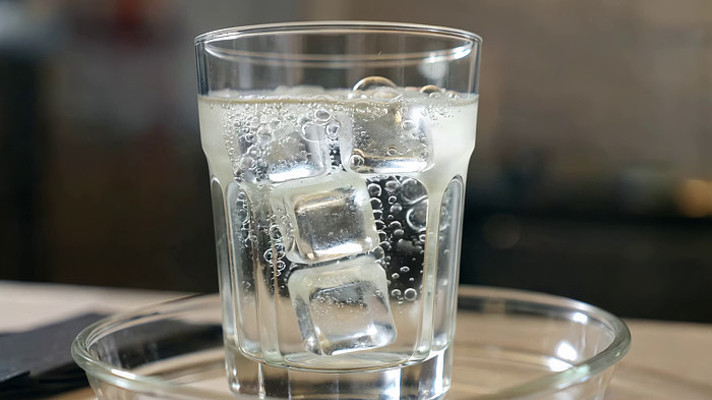 玻璃杯中的气泡水与冰块